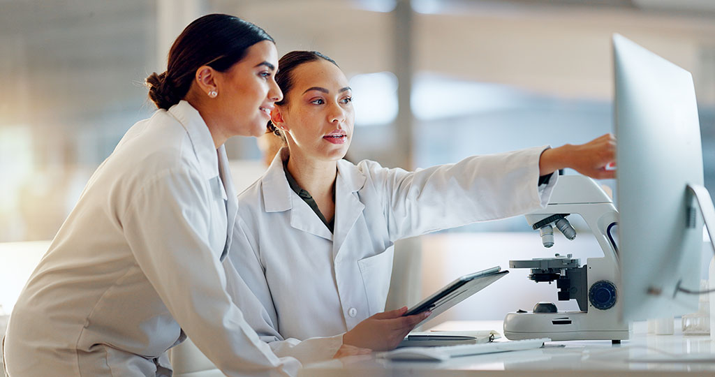 Scientist, Women And Teamwork On Tablet And Computer For Laboratory Advice, Medical Research And Night Planning. Students, Science People Or Mentor On Digital Technology Of Test Results Or Comparison