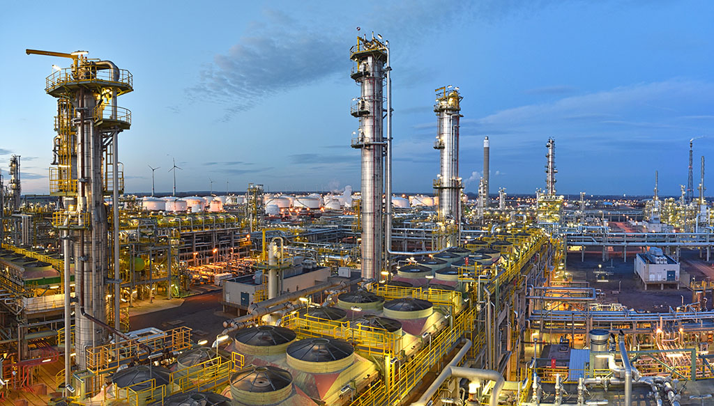 Refinery Chemical Factory At Night With Buildings, Pipelines A